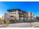 Modern home showcasing a unique architectural design with stone landscaping and a curved roofline at 11 Rockstream Dr, Henderson, NV 89012
