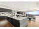 Bright, open kitchen with a marble island, stylish dark cabinetry, and seamless flow to the outdoor patio at 11 Rockstream Dr, Henderson, NV 89012