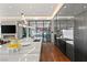 Modern kitchen featuring stainless steel appliances, marble countertops, and a glass-enclosed wine cellar at 11 Rockstream Dr, Henderson, NV 89012