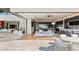 Open-concept living area flowing to an outdoor patio with a pool, modern furniture, and expansive views at 11 Rockstream Dr, Henderson, NV 89012