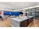 Open-concept living area with an expansive island, modern lighting, and elegant wine cellar at 11 Rockstream Dr, Henderson, NV 89012