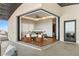 Gorgeous main bedroom with neutral tones connects to a patio with sleek seating and beautiful views of the city at 11 Rockstream Dr, Henderson, NV 89012