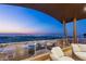 Stylish patio with comfortable seating and glass railings showcases spectacular city vistas, ideal for relaxation and entertainment at 11 Rockstream Dr, Henderson, NV 89012