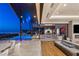 An open patio transitions to a spacious living area with a fireplace and city view backdrop at 11 Rockstream Dr, Henderson, NV 89012