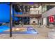 Expansive covered patio with a central fire pit, pool, and seamless indoor-outdoor living at 11 Rockstream Dr, Henderson, NV 89012