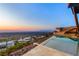 Infinity pool provides breathtaking panoramic views of the city and mountains during sunset at 11 Rockstream Dr, Henderson, NV 89012