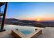 Stunning infinity pool with integrated spa, showcasing mountain and sunset views at 11 Rockstream Dr, Henderson, NV 89012