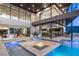 Stunning backyard pool area featuring a central fire pit and seamless access to the home at 11 Rockstream Dr, Henderson, NV 89012