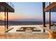 Infinity pool and fire pit offering panoramic city and mountain views at sunset at 11 Rockstream Dr, Henderson, NV 89012
