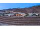 View of a multi-level luxury home, showcasing the outdoor space and hillside setting at 11 Rockstream Dr, Henderson, NV 89012