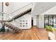 Modern staircase with glass railings, hardwood steps, and contemporary design at 11 Rockstream Dr, Henderson, NV 89012