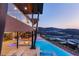 Luxury home featuring a sparkling pool, fire pit, and covered outdoor lounge area for ultimate relaxation and entertaining at 11 Rockstream Dr, Henderson, NV 89012