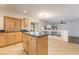 Open kitchen features wood cabinets, granite counters, an island and tile flooring at 11017 Ladyburn Ct, Las Vegas, NV 89141