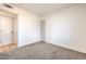 This bedroom offers neutral carpet, white walls, closet, and an open doorway at 1209 S 17Th St, Las Vegas, NV 89104