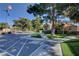 Exterior view of a community building with a well-maintained lawn, mature trees, and American flag at 1420 Ibizo St, Las Vegas, NV 89117