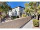 Two story home with a front yard surrounded by brick wall and shrubbery at 1420 Ibizo St, Las Vegas, NV 89117