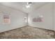 Large bedroom with neutral colored carpet, high ceilings, and multiple windows at 1562 Pimlico Hills St, Henderson, NV 89014