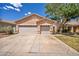 A charming home featuring a three-car garage and lush green landscaping at 1562 Pimlico Hills St, Henderson, NV 89014