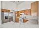 Well-lit kitchen with stainless steel appliances, white countertops, and wooden cabinetry at 1562 Pimlico Hills St, Henderson, NV 89014