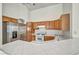 Well-lit kitchen with stainless steel appliances, white countertops, and wooden cabinetry at 1562 Pimlico Hills St, Henderson, NV 89014