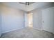 Carpeted bedroom featuring ceiling fan, closet, neutral colored walls, and white trim at 189 Kings Canyon Ct, Henderson, NV 89012