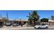 Charming single-story home featuring desert landscaping, mature trees, and ample parking at 1902 Weldon Pl, Las Vegas, NV 89104