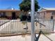 Landscaped front yard area with ornamental metal fencing, rock, and desert plants at 1902 Weldon Pl, Las Vegas, NV 89104