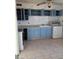A kitchen featuring blue cabinetry, ample counter space, and modern appliances at 1902 Weldon Pl, Las Vegas, NV 89104