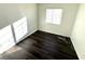 A vacant room featuring dark laminate flooring and white walls with a window at 1920 Hodgenville St # 106, Las Vegas, NV 89106