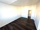 A vacant room featuring dark laminate flooring and white walls at 1920 Hodgenville St # 106, Las Vegas, NV 89106