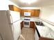 Efficient kitchen with oak cabinets, updated countertops, and essential appliances included at 1920 Hodgenville St # 106, Las Vegas, NV 89106