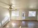 Bright living room featuring tile floors, a ceiling fan, and a sliding glass door for natural light at 1920 Hodgenville St # 106, Las Vegas, NV 89106