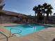 Community pool with clear water and a surrounding deck for lounging and relaxation at 1920 Hodgenville St # 106, Las Vegas, NV 89106