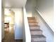 A carpeted staircase leading to the upper level of the home at 1920 Hodgenville St # 106, Las Vegas, NV 89106