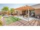 Inviting backyard patio with a hot tub, outdoor seating, and a covered pergola at 1920 Silver St, Pahrump, NV 89048