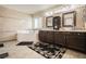 Bathroom with a tub, and sinks, dark wood vanities, and decorative mirrors at 1920 Silver St, Pahrump, NV 89048