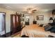 Bedroom with a bed, ceiling fan, wood floors, and a bathroom at 1920 Silver St, Pahrump, NV 89048