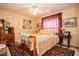 Bedroom with yellow walls, carpet, ceiling fan, and various pieces of art displayed at 1920 Silver St, Pahrump, NV 89048