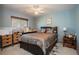 Bedroom with blue walls, carpet, ceiling fan, and natural light from the window at 1920 Silver St, Pahrump, NV 89048