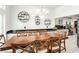 Dining room featuring a chandelier, wall decorations, and view into the kitchen with light grey cabinetry at 1920 Silver St, Pahrump, NV 89048