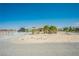 Wide angle showing the home's gravel front yard and fenced perimeter at 1920 Silver St, Pahrump, NV 89048
