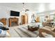 Open-concept living room with fireplace, ceiling fans, tile floors, and neutral tones for a comfortable living space at 1920 Silver St, Pahrump, NV 89048