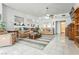 Open living space featuring tile floors, comfortable seating, and seamless flow between the living and dining areas at 1920 Silver St, Pahrump, NV 89048