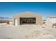 Large metal shed with an open door full of tools and storage, with gravel surrounding it at 1920 Silver St, Pahrump, NV 89048