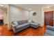 Comfortable living room featuring a gray sofa with wood-look floors and a stylish world map decor at 2009 Emerald Green Ave, Las Vegas, NV 89106