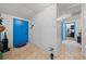 View of the home's entryway featuring bright walls, tile flooring, and blue front door at 214 Earl St, Las Vegas, NV 89101