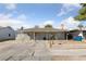 Single story home featuring covered porch and a spacious driveway under a bright sky at 214 Earl St, Las Vegas, NV 89101