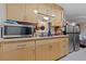 Galley kitchen with stainless steel appliances, granite countertops, and bright cabinets at 214 Earl St, Las Vegas, NV 89101