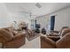 Spacious living room with tile flooring, a ceiling fan, and a cozy fireplace at 214 Earl St, Las Vegas, NV 89101