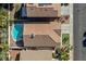Aerial view of a home with a pool, tile roof, and well-kept landscaping at 254 Camelback Ridge Ave, Henderson, NV 89012